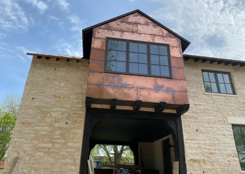 Copper metal panel facade on a stone building for Roof Repair in Rio Rancho
